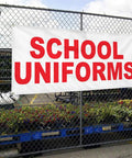 Industrial Grade Custom Printed Heavy Duty Vinyl Banner 24x48 Inches Red Education Design Hella Tough Weatherproof Outdoor Yard Sign With Four Grommets For Killer Campus Branding, displaying 'SCHOOL UNIFORMS' on a fence.