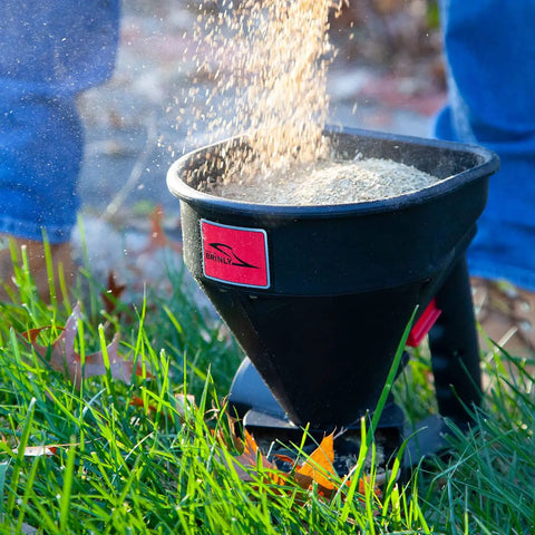 Five Pound All Season Handheld Spreader With Easy Fill Design for seed distribution in grassy area, rugged poly body, 5 lb capacity
