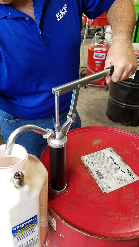 Person using Guardian Lever Action Drum Transfer Pump For 16 To 55 Gallon Drums With 2 Inch Bung And Bushing, 10 Oz Per Stroke