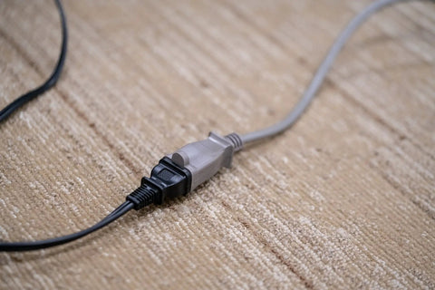 Light Duty 20 Foot Extension Cord For Small Appliances SVT 16 Gauge 125 Volt Indoor Use Gray with connected plug on carpet
