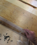 Quarter Inch Rubber Ball Cabinet Door Spacers Auto Center Alignment Tool on assembly table with wooden panel and spacer balls.