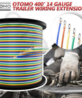 Beefed Up 400 Foot 14 Gauge Five Way Trailer Wire CCA Bonded Extension Cable Color Coded Primary Wire Spools For Trailer RV Camper Towing SAE J1128 Harness Green Yellow Brown White Blue visible with a mechanic's hand working in an engine bay.