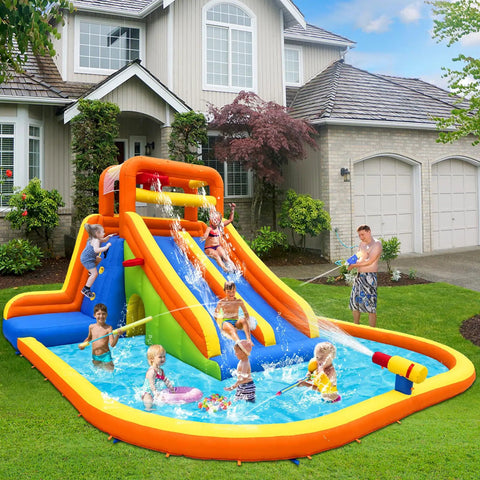 Kids playing on Giant Backyard Water Park with tall dual slides, climbing walls, splash pool, tunnel, and water cannon.
