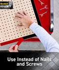 Applying double-sided heavy-duty mounting strips and tape to a pegboard, showing use instead of nails or screws for walls and outdoor use.