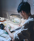 Man using Bifocal LED Magnifying Lamp With Clamp For DIYers, 5 Diopter Plus 20 Diopter, 5 Inch Glass Lens, at workspace