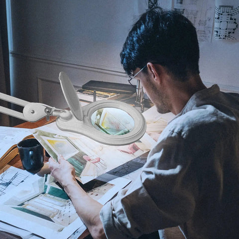 Man using Bifocal LED Magnifying Lamp With Clamp For DIYers, 5 Diopter Plus 20 Diopter, 5 Inch Glass Lens, at workspace