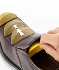 Memory Foam Shoe Inserts For Big Shoes Fit Unisex Toe Box Fillers being adjusted in brown shoe for wide feet comfort