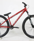 Red Salire SJ-50 Dirt Jumper Bike With Disc Brakes And 26 Inch Wheels, steel frame, and 100mm suspension fork in side view.