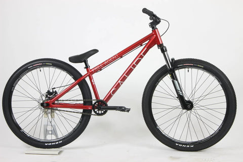 Red Salire SJ-50 Dirt Jumper Bike With Disc Brakes And 26 Inch Wheels, steel frame, and 100mm suspension fork in side view.
