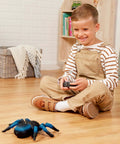 Child playing with Remote Control Tarantula For Kids With LED Eyes Realistic Spider Toy With Moving Legs Fast Speed And 360 Degree Spin Blue RC