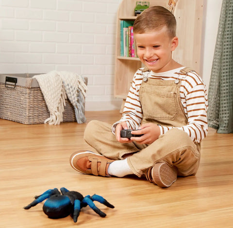 Child playing with Remote Control Tarantula For Kids With LED Eyes Realistic Spider Toy With Moving Legs Fast Speed And 360 Degree Spin Blue RC