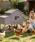 Backyard Chicken Coop On Wheels With Run Kit Large Wooden Hen House With Waterproof Roof next to family and chickens