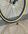 Aluminum Alloy Bicycle Axle Cap for Front and Rear Wheel Hubs shown next to a bicycle wheel for easy install and secure fit.