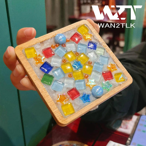 Hand holding colorful mosaic tile art piece using white mosaic crystal grout 200G no water needed direct caulking for mosaics.