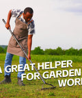 Person using Beefy 63 Inch Heavy Duty Metal Garden Rake With Ergonomic Handle 17 Tines on grass, wearing apron, outdoors.