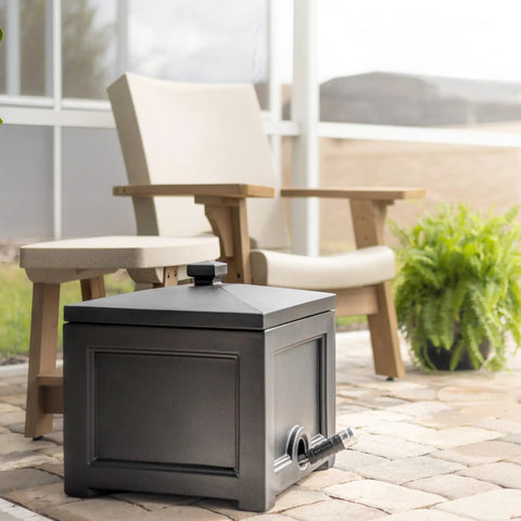Black garden hose bin storage box outdoors, next to patio chairs, holds up to 100 ft hose, 17x17x18 in, UV fade resistant, weatherproof.