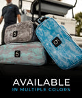 Beast Of A Tackle Bag For Fishing Gear And Soft Plastics, Extra Large, displayed in various colors on a dock.