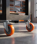 Close-up of 4pcs Inch TPR Swivel Caster Wheels with Brake, M8 Post mounted on a heavy-duty cart.