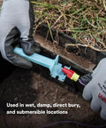 Front view of blue Direct Bury Splice Kit component with red and yellow connectors and a purple wire
