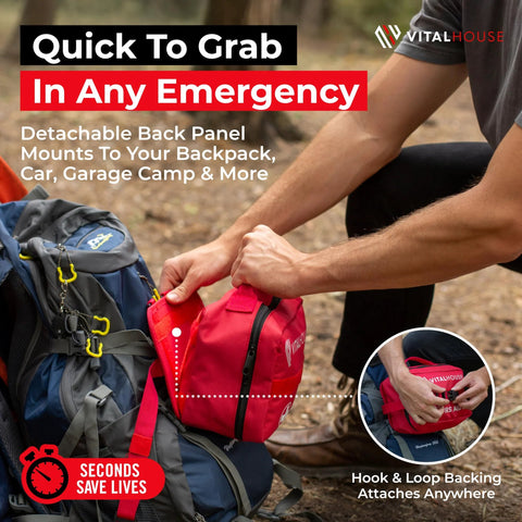 Red compact first aid kit with zipper, attached to blue hiking backpack via hook-and-loop; VitalHouse logo visible