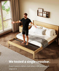 Heavy Duty Queen Bed Frame Sag Saver Center Support Cross Bars Steel Reinforcement Kit shown on wooden bed. Man stands on bed.