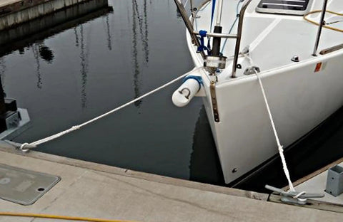 Paracord 550 Nylon Rope For Camping And Hiking securing a boat at dock, showing strong 1/4 inch thick white cord tensioned for stability