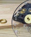 Close-up of 13 Piece Brass Router Template Bushing Guides Set with carrying case, showing brass bushings and acrylic plate detail.