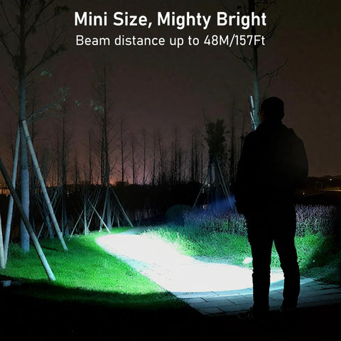 Person using EDC Rechargeable Keychain Flashlight 360 Lumen Mini Pocket Light in park at night, beam illuminating path