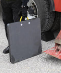 Person holding HDPE Outrigger Pad 18x18x1 Inch Heavy Duty Jack Pad for Utility Trucks Cranes RVs Trailers with rope handle