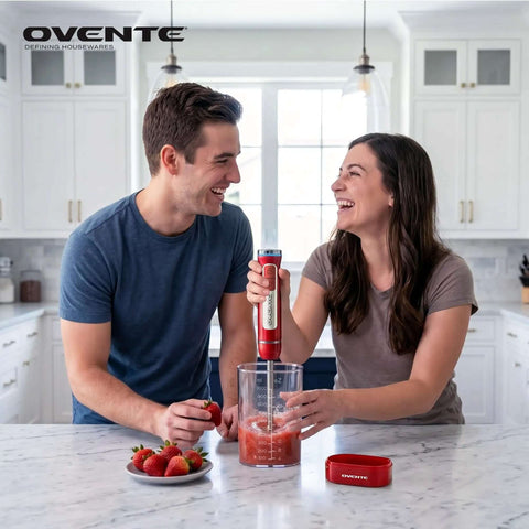 Couple using Rechargeable Cordless Hand Blender With 8 Speeds Red HR781R for smoothies in a kitchen with strawberries.