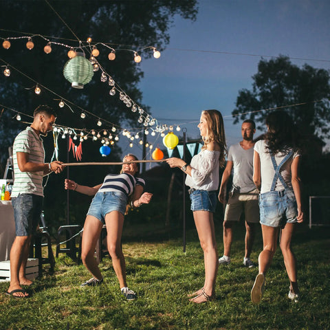 Outdoor string light poles 2 pack 10 ft tall ground insertion for backyard parties and weddings, people enjoying festive decor