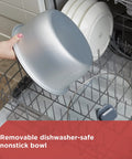 Hand placing removable nonstick bowl from Rice Cooker With 6 Cup Cooked Capacity, No Fuss Steaming Basket into dishwasher.