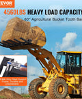 Yellow loader lifting hay with Clamp On Debris Forks For 60 Inch Buckets With 10mm Thick Ends And 4560 Lbs Load Capacity.