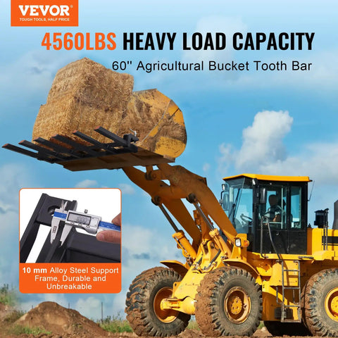 Yellow loader lifting hay with Clamp On Debris Forks For 60 Inch Buckets With 10mm Thick Ends And 4560 Lbs Load Capacity.