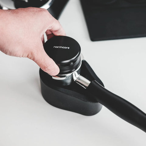 Hand using 51mm Espresso Coffee Distribution Tool With Adjustable Depth For Even Tamp And Consistent Extraction Leveling Coffee Leveler