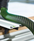 Heavy Duty Suction Hose 27 By 32 Millimeter By Five Meter For CT Dust Extractors Including CT 15 25 26 36 48 And CT Mini Midi From 2019 Onward With Flexible Inner Core And Rugged Outer Skin For Easy Snag Free Setup attached to cutting tool on workbench.