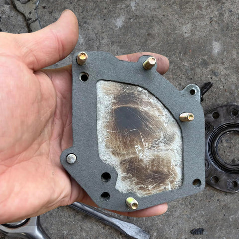 Nkiy Quen non-asbestos gasket sheet, gray outer layer with metal-reinforced center, 15 x 11.8 in, bolt holes visible.