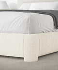 Snug Twin Bed Frame With Ultra Soft Cloud Boucle Fabric And Cream Upholstered Headboard featuring rounded corners and soft bedding.