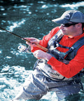 Angler wearing Ultra Lightweight Fly Fishing Vest With 14 Pockets And Front Zip Storage Olive Green in a river