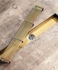 Stainless Steel Rectangle Floor Drain Insert With Pop Off Grate And Hair Catcher Stops Hair Snafus Quick Flow Action And Pull Out Tray on wood floor.