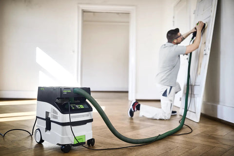 CT MIDI I Dust Extractor With HEPA Filter, Bluetooth Start, AutoClean System, in use during door sanding project