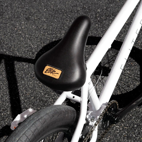 Close-up of black seat and tire on BMX Freestyle Bike With Durable Steel Frame In White, Available In 16, 18, 20, 26, And 29 Inch Sizes