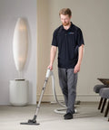 Person using Universal 30 Ft Central Vacuum Kit With Suction Driven Turbo Nozzles For Versatile Cleaning On Hard Floors Surfaces
