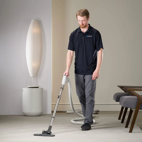 Person using Universal 30 Ft Central Vacuum Kit With Suction Driven Turbo Nozzles For Versatile Cleaning On Hard Floors Surfaces