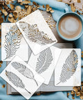 Awesome Boho Feather And Mandala Stencil Set, Six Durable PET templates on a book with a cup of coffee.