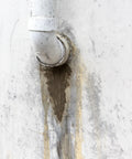 Professional Grade Fast Setting Hydraulic Cement Seals Basement Leaks And Anchors Fence Posts On Concrete With A Hella Tough Rock Solid Patch applied to pipe leak in concrete wall.