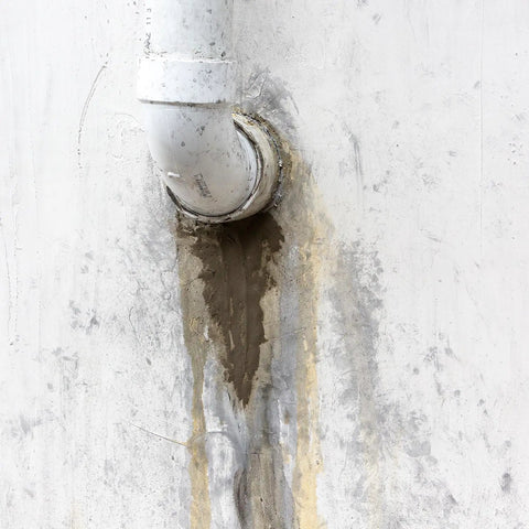 Professional Grade Fast Setting Hydraulic Cement Seals Basement Leaks And Anchors Fence Posts On Concrete With A Hella Tough Rock Solid Patch applied to pipe leak in concrete wall.