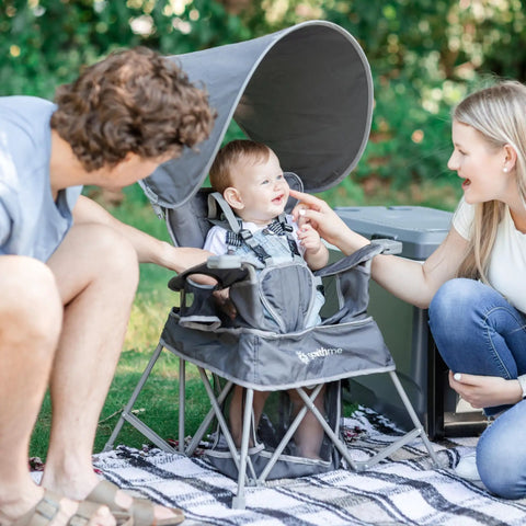Go With Me Venture Portable Toddler Chair On The Go with sun canopy in grey, showing family using chair outdoors, folds flat in carry bag