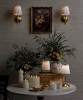 BSFHKLA Cordless Rechargeable Wall Sconce with Scalloped Fabric Shade and Remote, Brass Finish, USB, Dimmable LED Lighting(WhiteVelvet) in ambient setting with flowers.