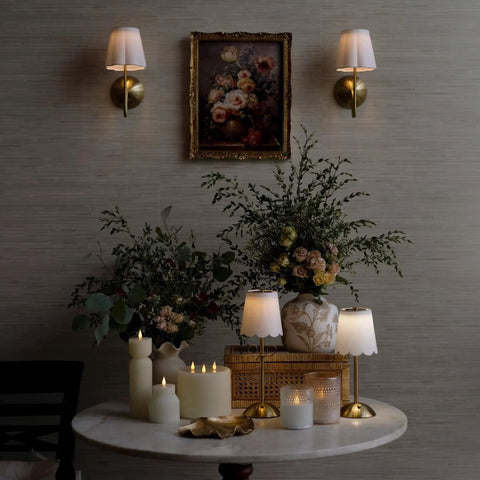 BSFHKLA Cordless Rechargeable Wall Sconce with Scalloped Fabric Shade and Remote, Brass Finish, USB, Dimmable LED Lighting(WhiteVelvet) in ambient setting with flowers.